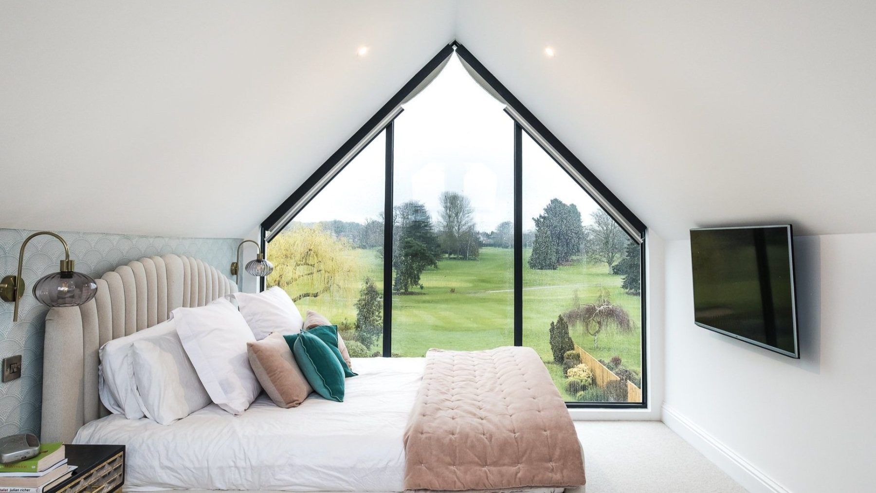 An internal view of the principal bedroom in the loft conversion at Topsham Road; with the large gable end feature window looking across Exeter Golf and Country Club in the background.