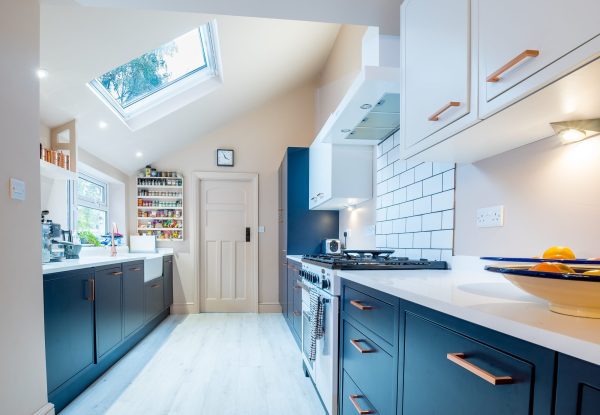 An internal view of the kitchen with rooflight above, looking from the dining area.