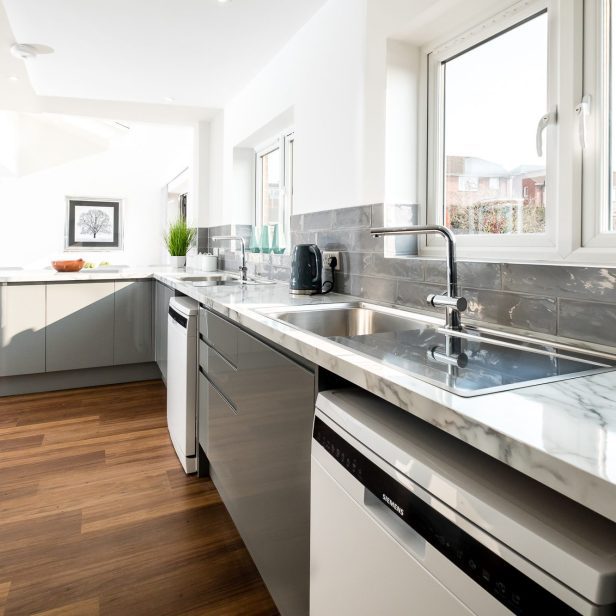 A close up internal view of the kitchen with the dining area in the background at Church Street.